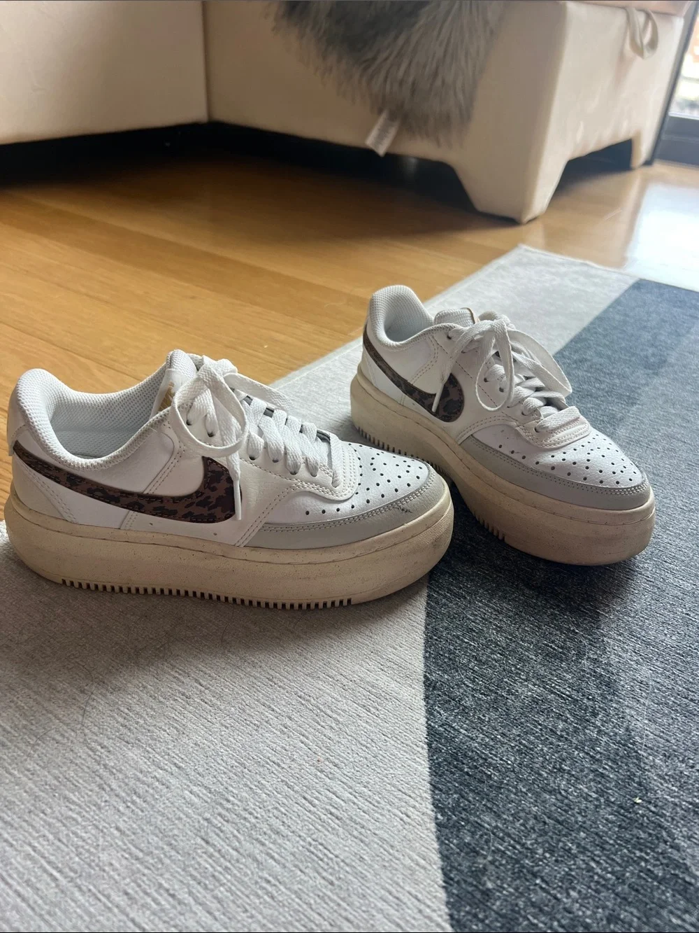 Nike sneakers with leopard print swoosh